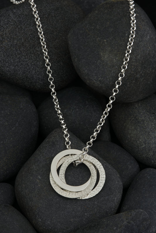 Silver textured, three ring pendant