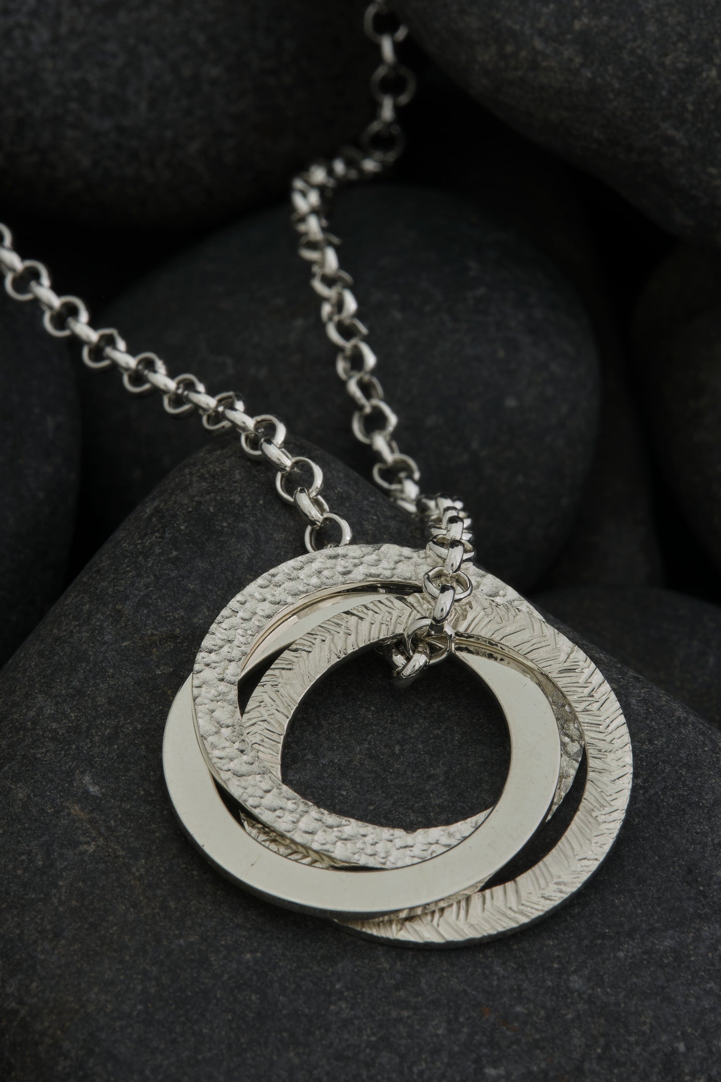 Silver textured, three ring pendant